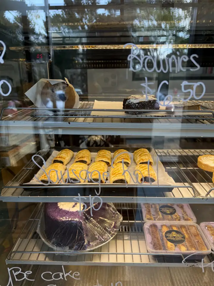 The cake cabinet with brownies, danishes and an ube cake