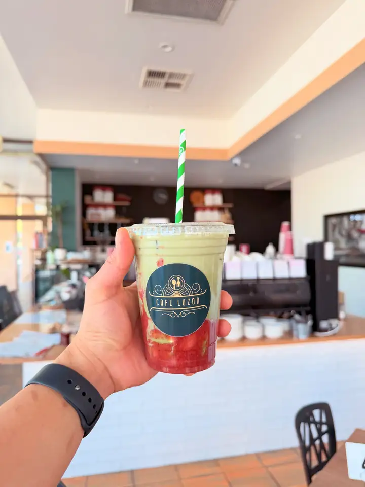 An iced strawberry matcha in a Café Luzon cup